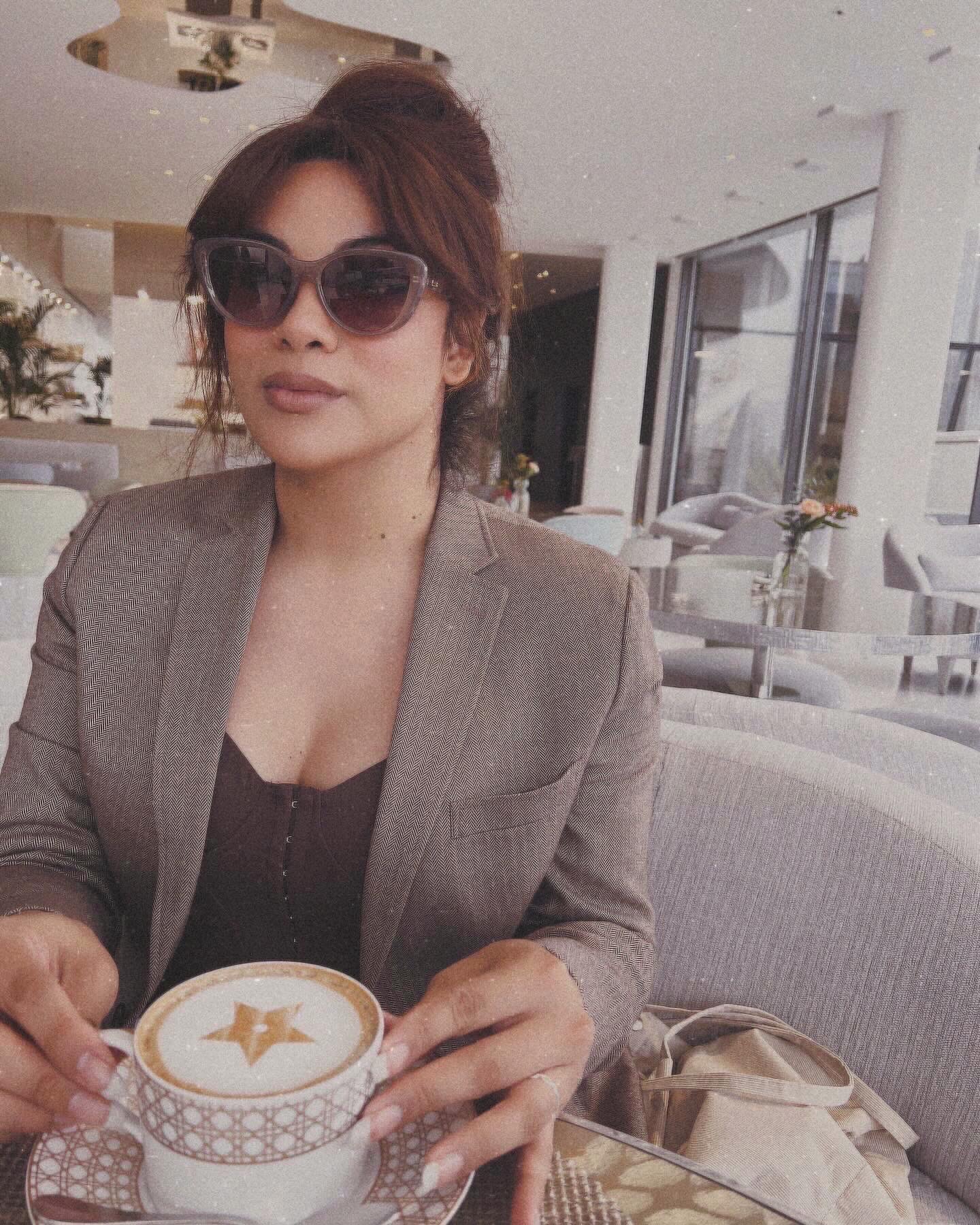 A guest enjoying coffee in a modern café space at Hotique.